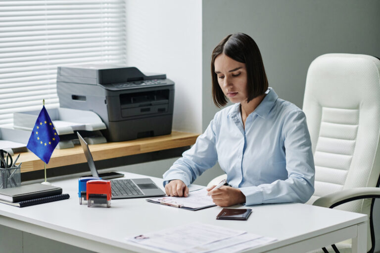 young specialist sitting her workplace filling form vsia